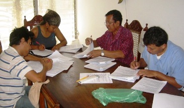 CE volunteers correcting tareas photo